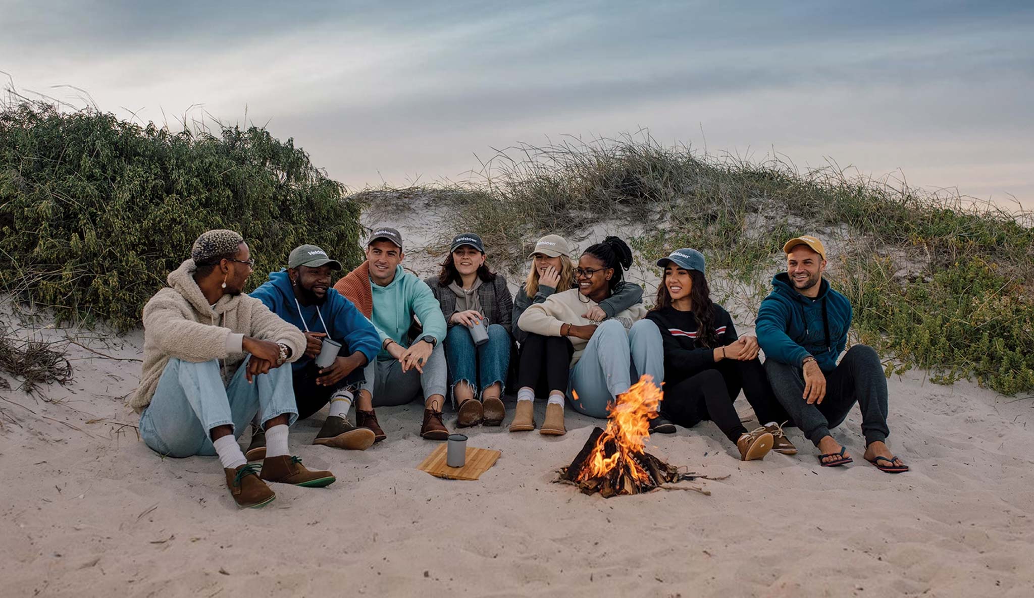 Veldskoen travellers sitting by fire