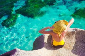 Relaxing on the rocks over the sea in Seychelles